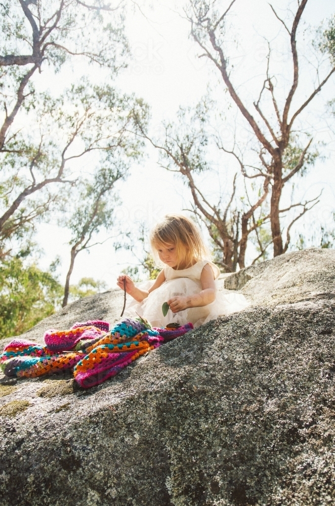 Young girl playing on a huge boulder - Australian Stock Image
