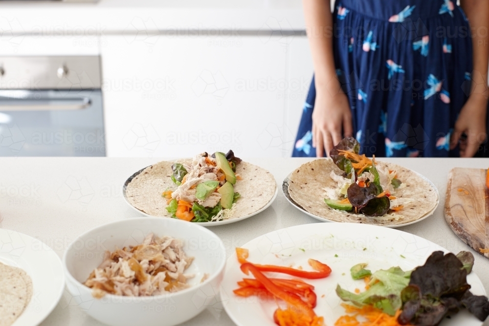 Young girl preparing healthy lunch in kitchen - Australian Stock Image