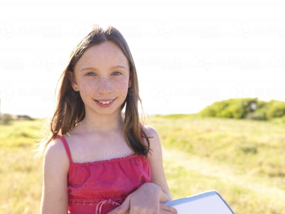 Young girl preparing to go body boarding - Australian Stock Image