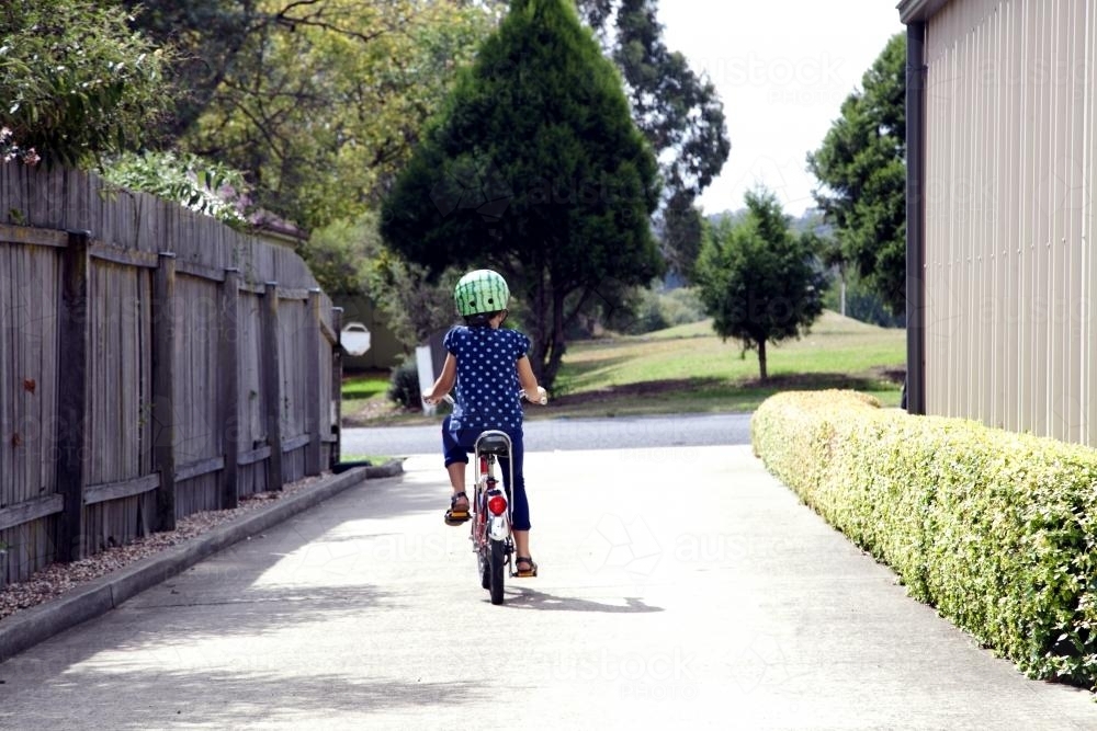 Young girl riding bike - Australian Stock Image