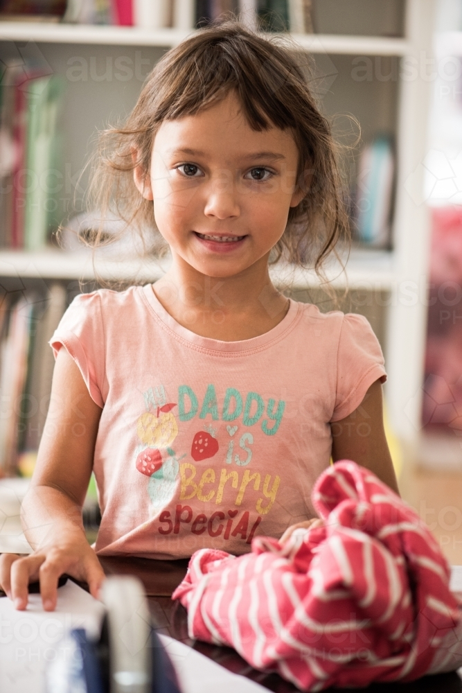 Young girl smiling indoors. - Australian Stock Image