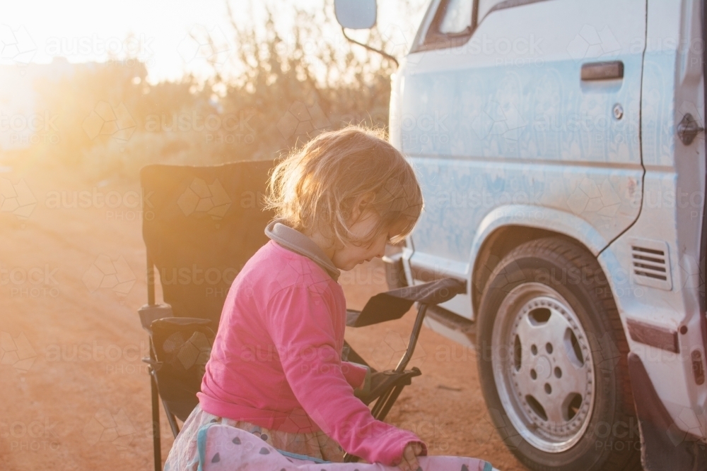Young girl standing by campervan - Australian Stock Image
