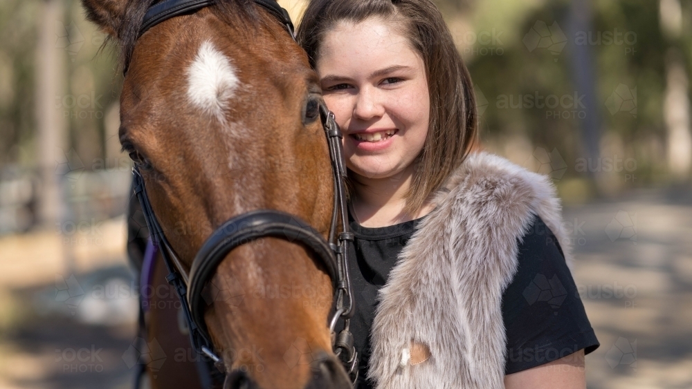 Young girl standing close to her horse - Australian Stock Image