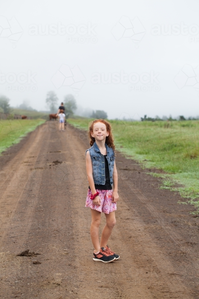 Young girl standing on a dirt track - Australian Stock Image