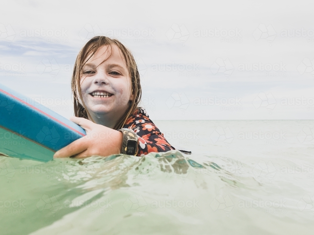 young girl surfing a boogie board - Australian Stock Image