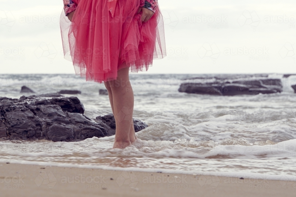 Young girl walking in the water - Australian Stock Image