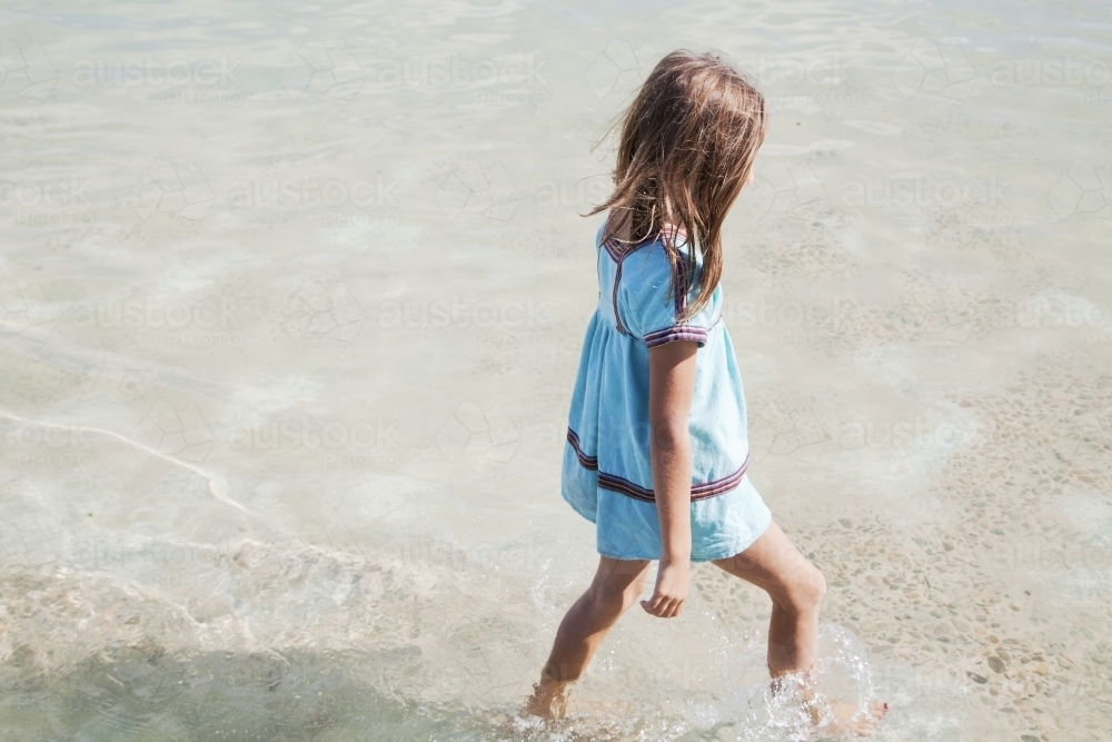 Young girl walking in water - Australian Stock Image