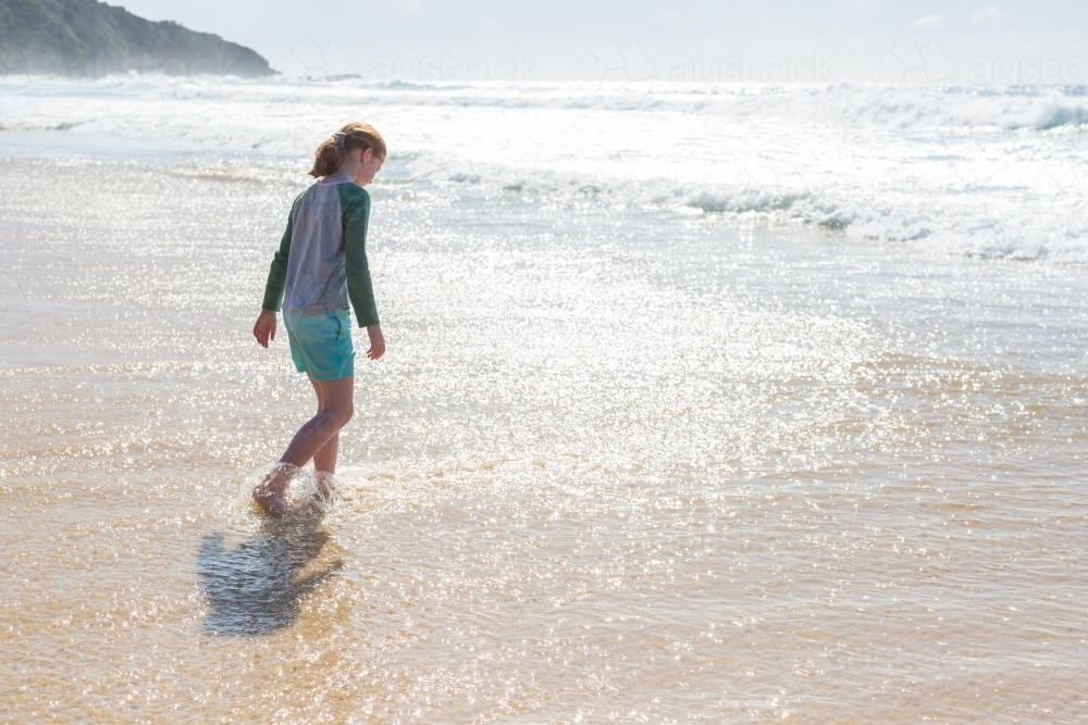 Young girl walking into the water at Blueys beach - Australian Stock Image