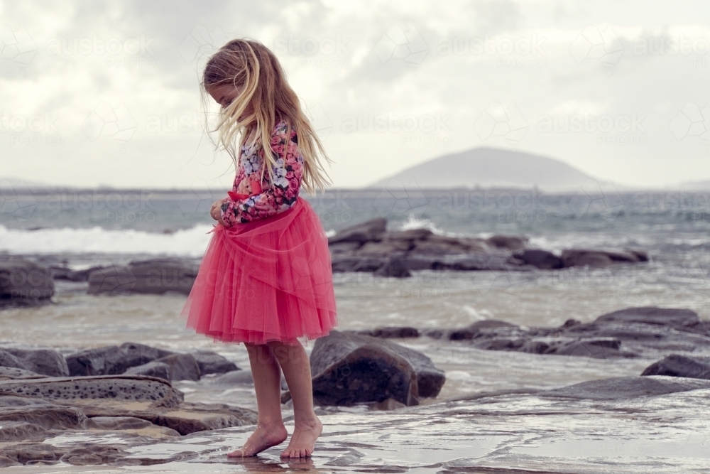 Young girl walking on beach - Australian Stock Image