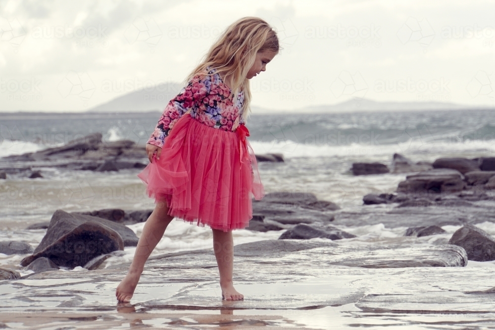 Young girl walking on beach - Australian Stock Image