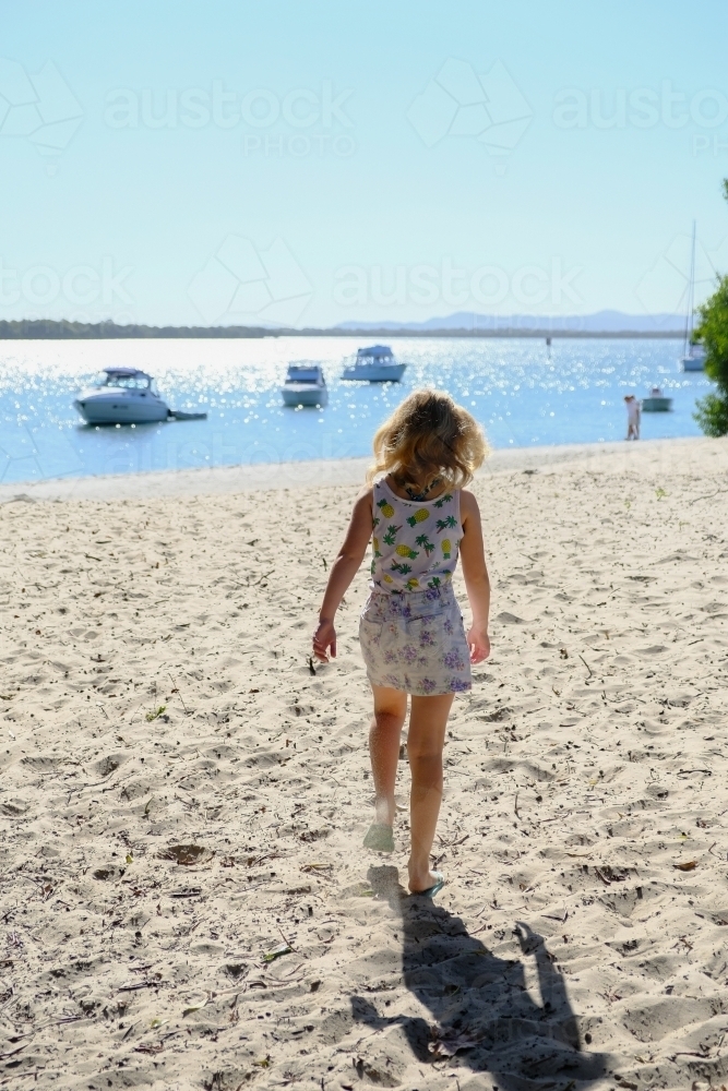 Young girl walking towards the beach - Australian Stock Image