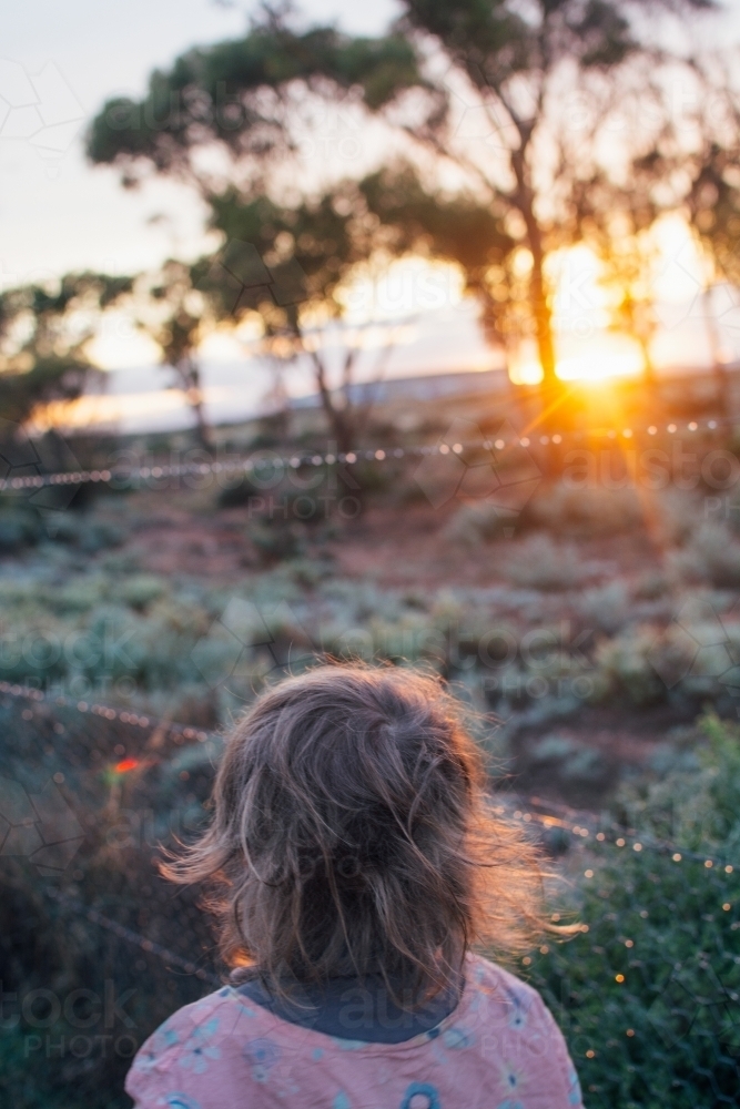 Young girl watching sunrise - Australian Stock Image