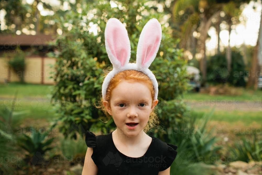 Young girl wearing Easter bunny ears - Australian Stock Image