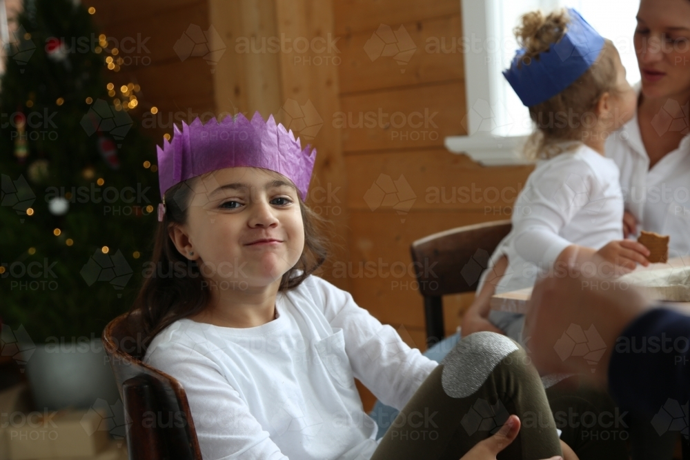 Young girl wearing purple paper hat - Australian Stock Image