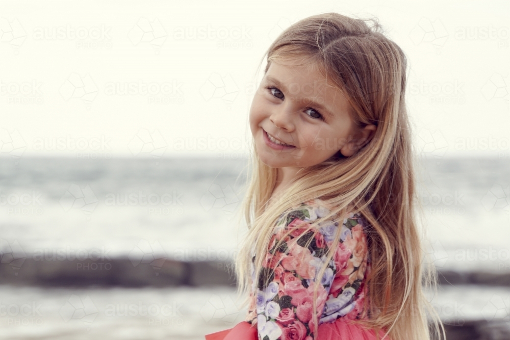 Young girl with blonde hair smiling back - Australian Stock Image