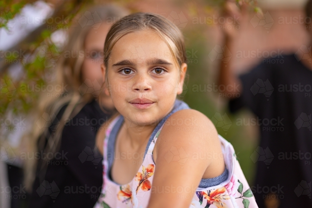 young girl with brown eyes centred looking at camera - Australian Stock Image