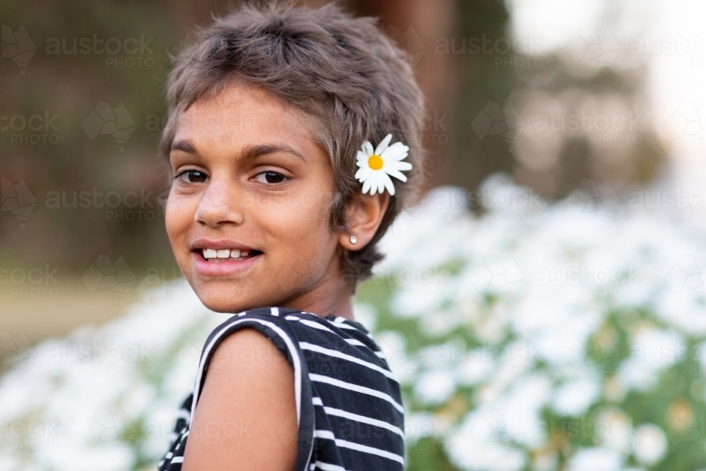 young girl with daisy in her hair - Australian Stock Image