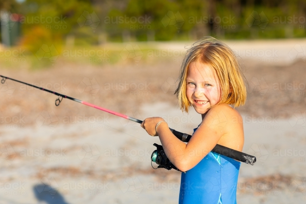 young girl with fishing rod - Australian Stock Image