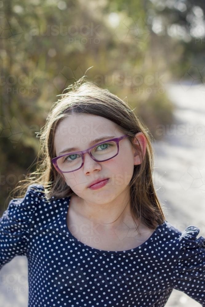 Young girl with glasses in bushland - Australian Stock Image