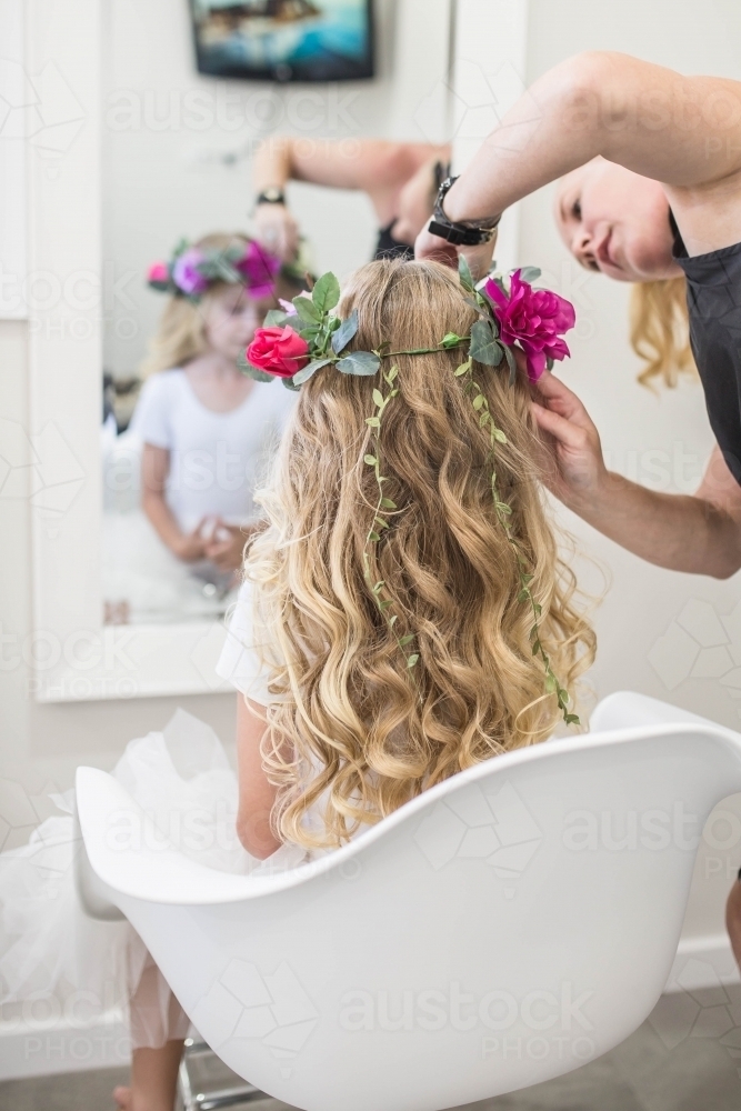 Young girl with long blonde hair getting flower crown - Australian Stock Image