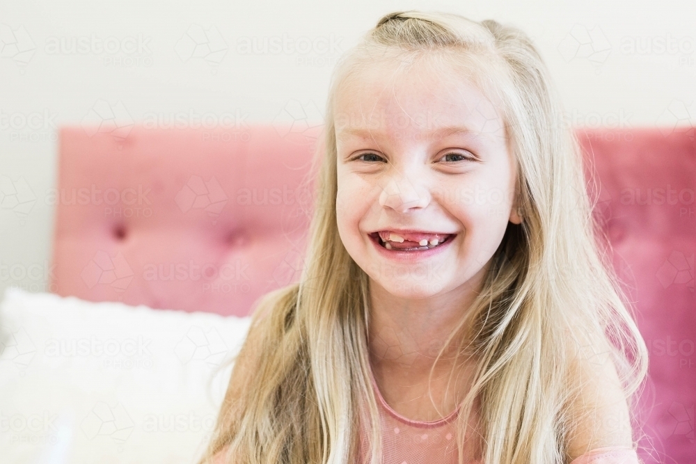 Young girl with long blonde hair smiling - Australian Stock Image