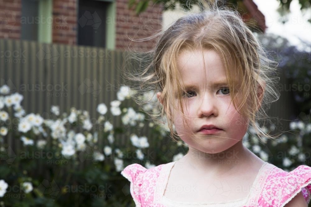 Young girl with messy hair in the garden - Australian Stock Image