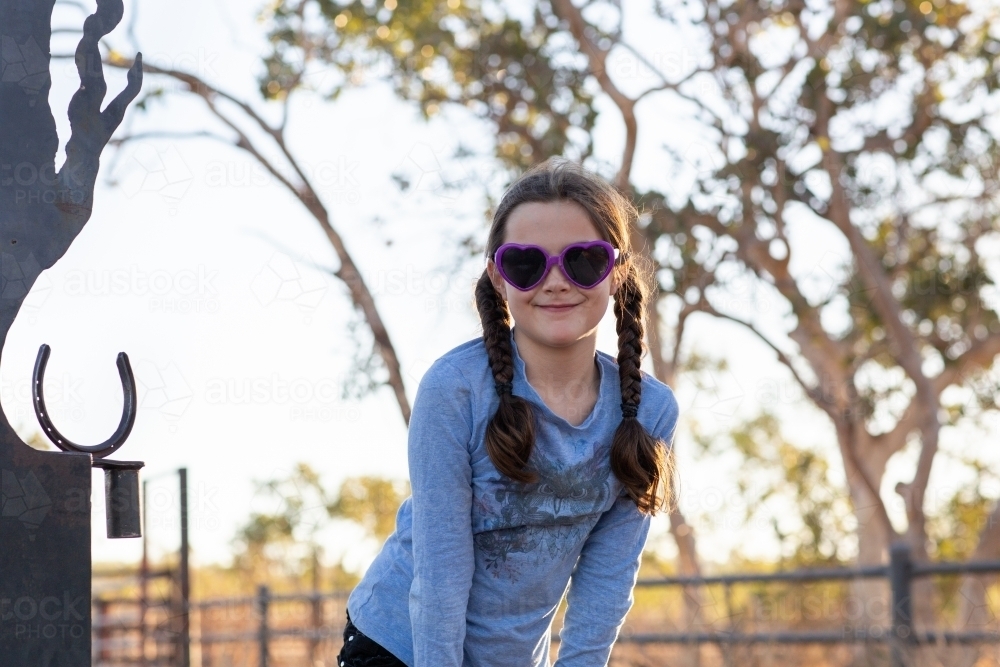 Young girl with plaits and sunglasses - Australian Stock Image