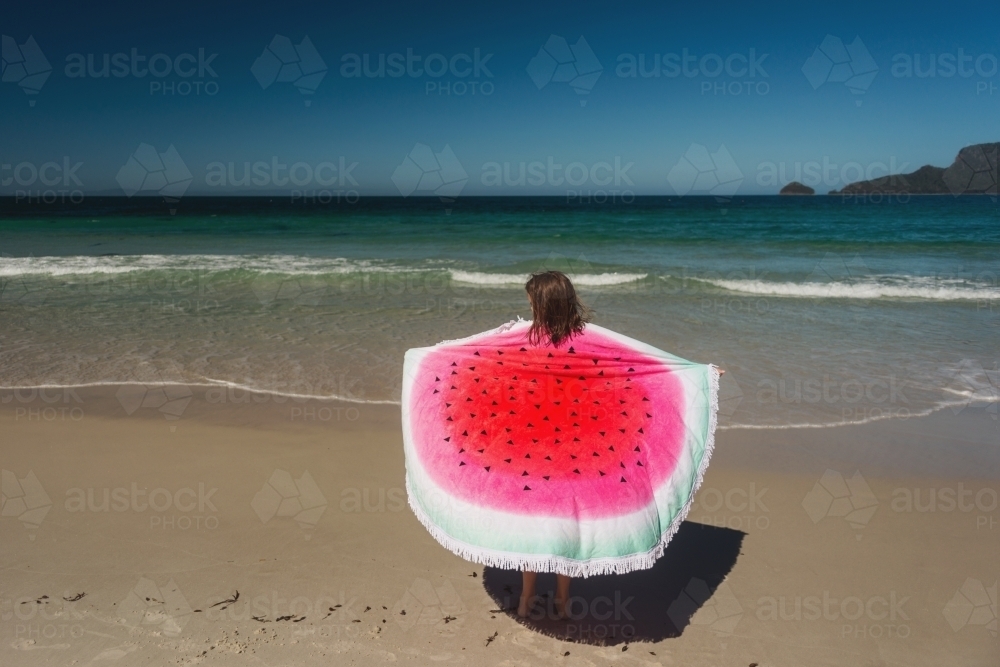 young girl with watermelon towel at the beach - Australian Stock Image