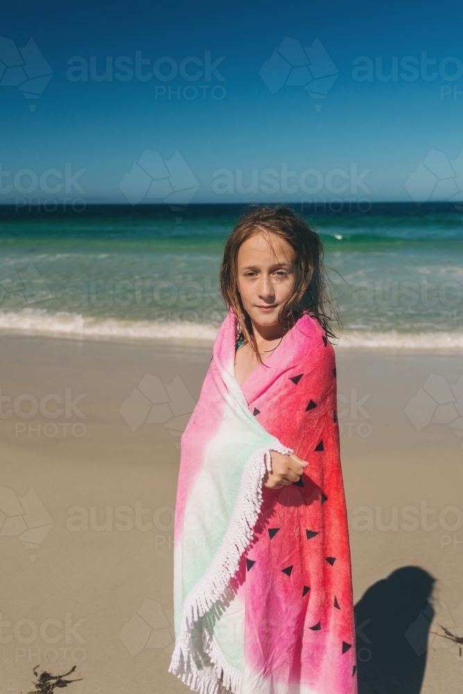 young girl with watermelon towel at the beach - Australian Stock Image