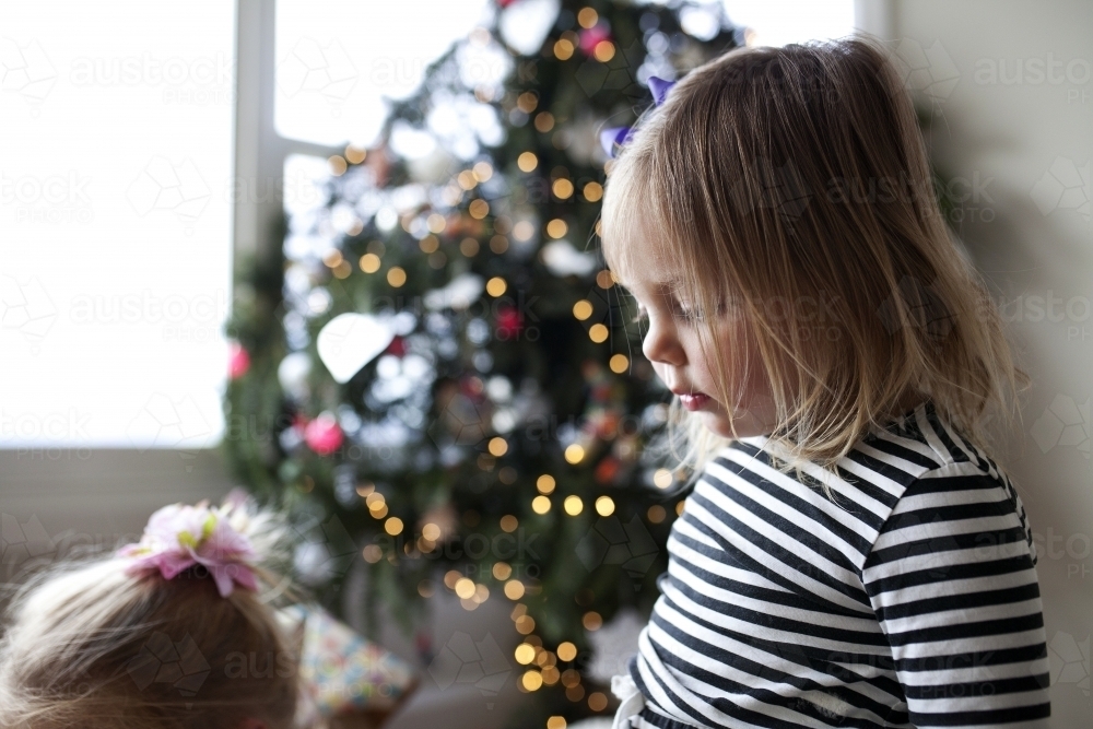 Young girls in front of Christmas tree - Australian Stock Image