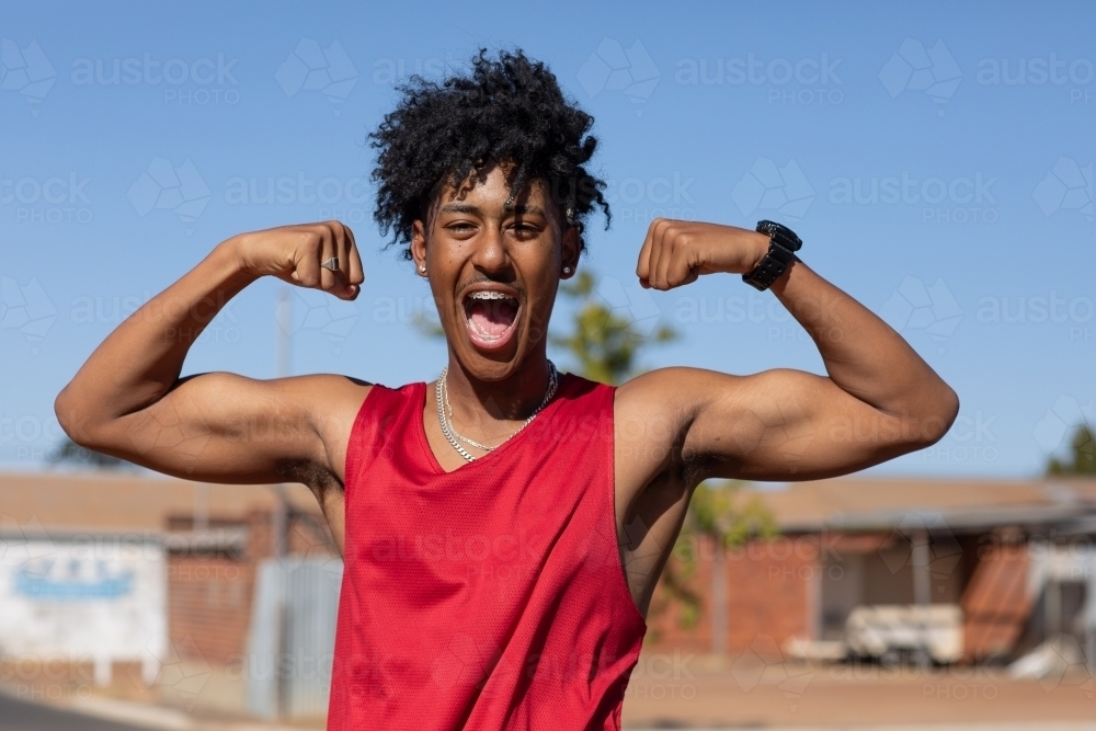 young guy flexing his muscles and being fierce - Australian Stock Image