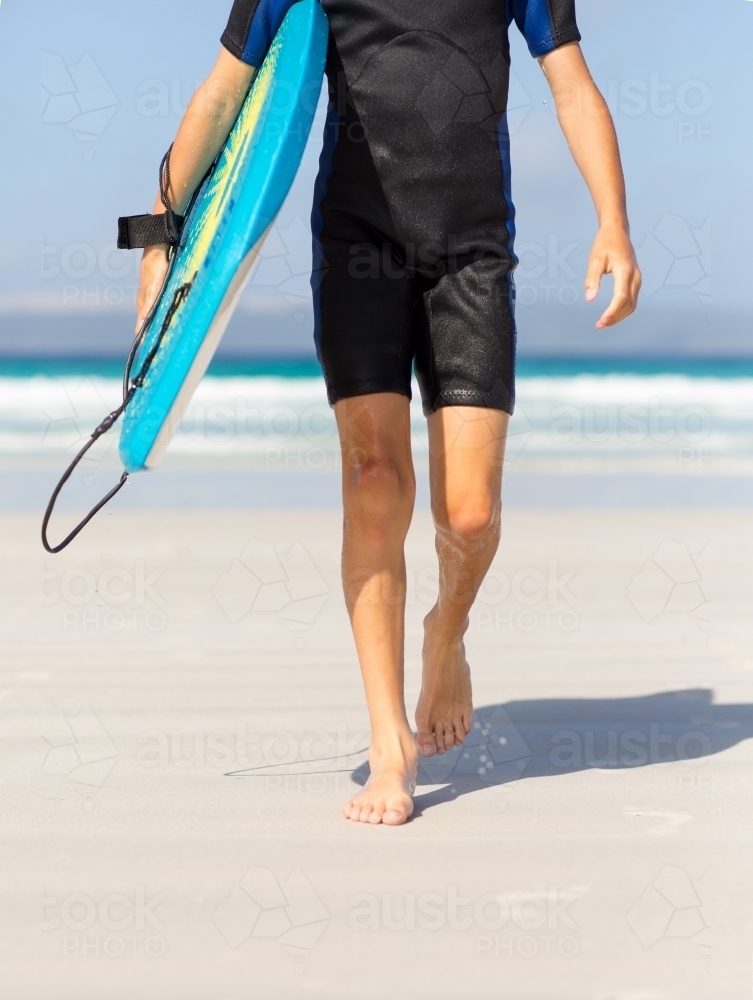 young kid on the beach with body board - Australian Stock Image