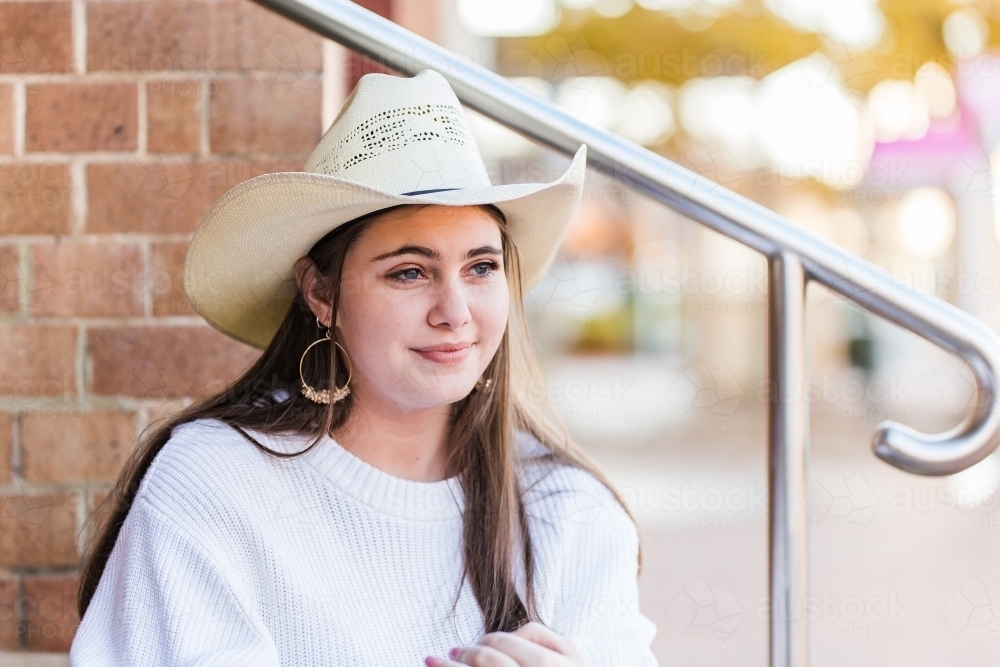 Young lady looking off into distance wearing hat - Australian Stock Image