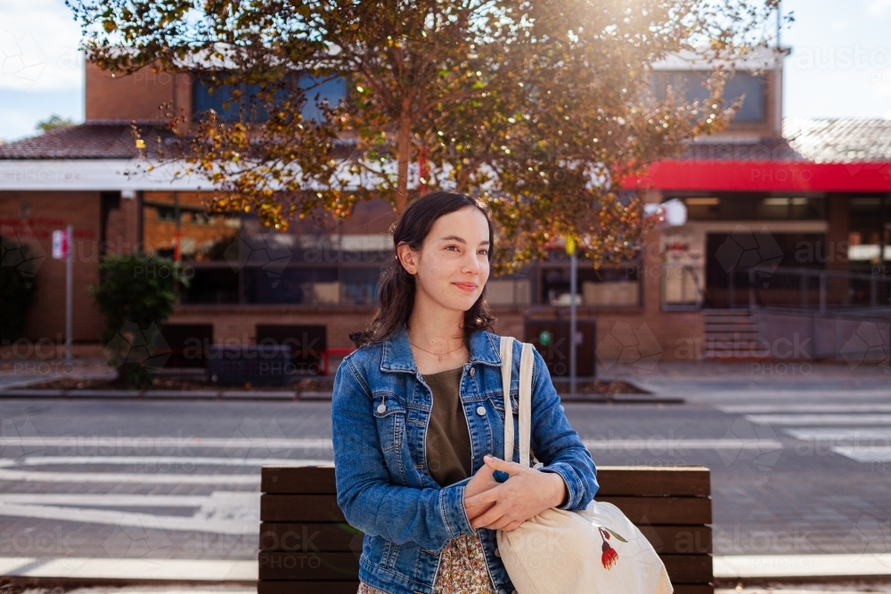 Young lady outside post office in country town shopping - Australian Stock Image