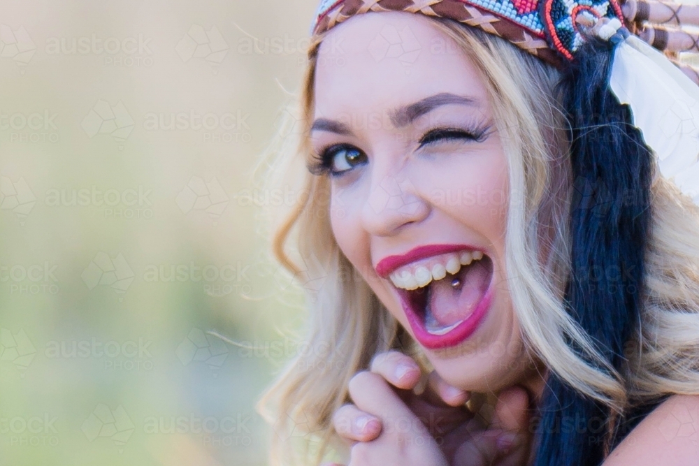 Young lady winking with mouth open - Australian Stock Image