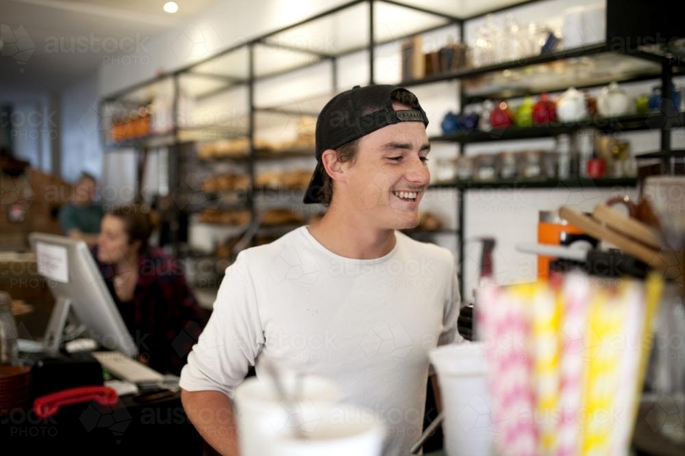 Young male barista working at cafe - Australian Stock Image