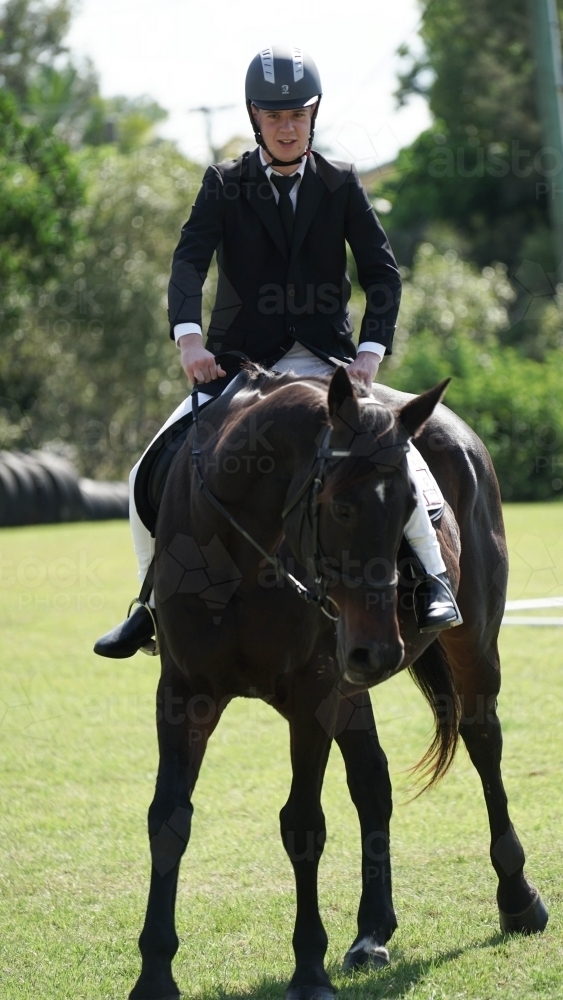 Young man competing in horse competition - Australian Stock Image