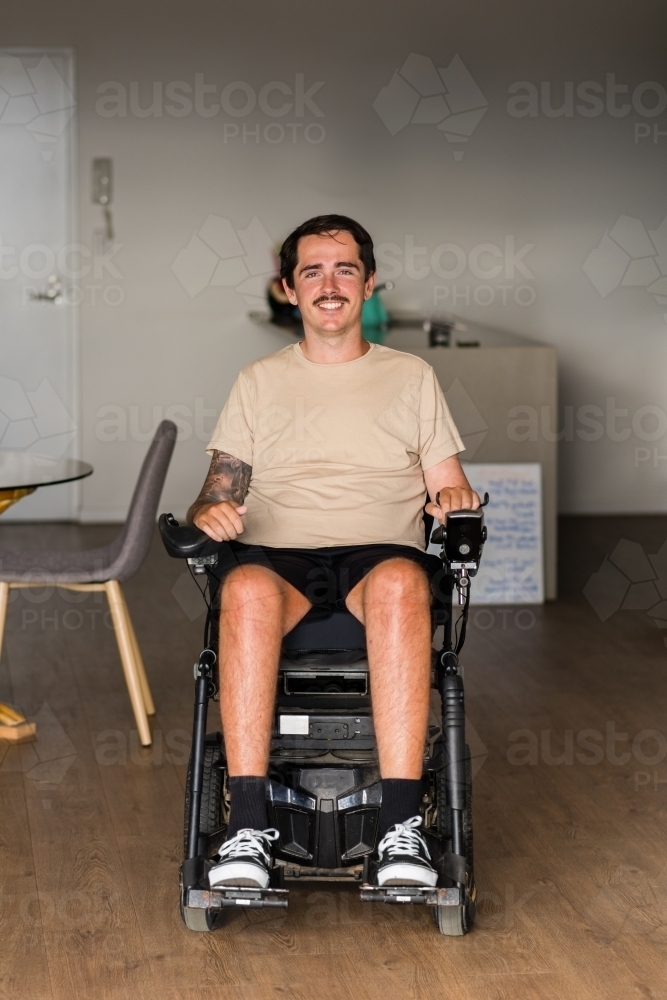 young man in motorised wheelchair - Australian Stock Image