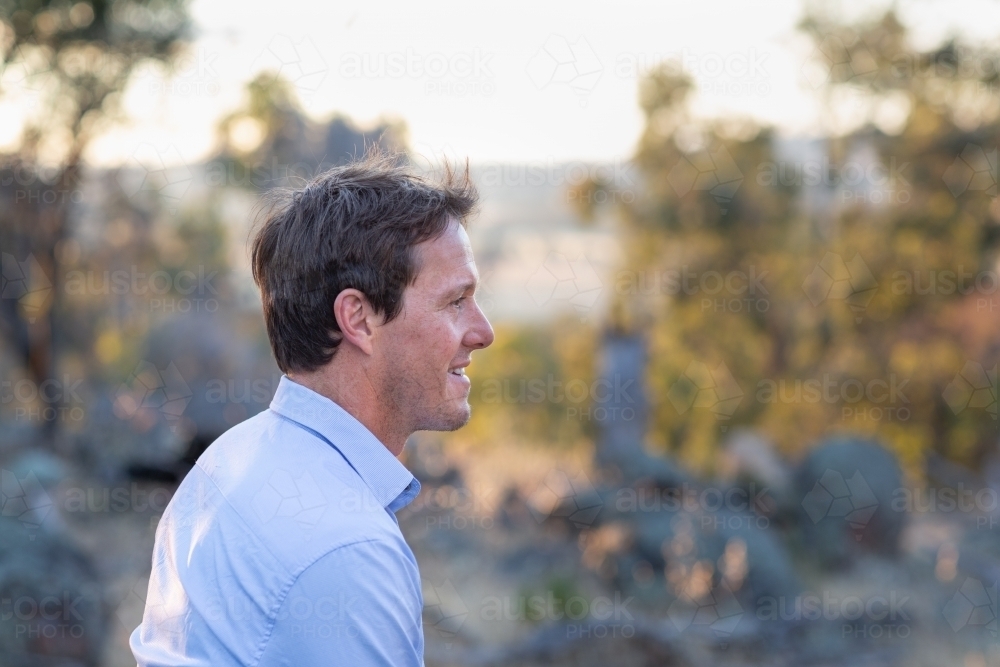 Young man in profile in countryside - Australian Stock Image