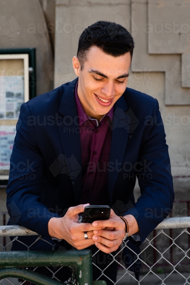 young man using mobile phone - Australian Stock Image