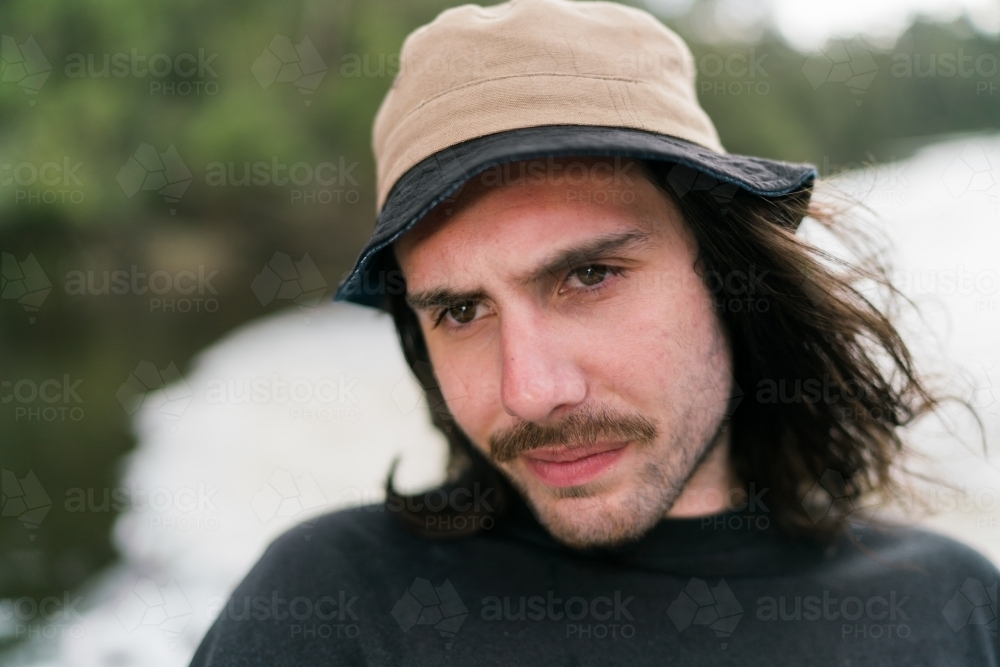 Young Man with a Brown Hat against a Blurred Background - Australian Stock Image