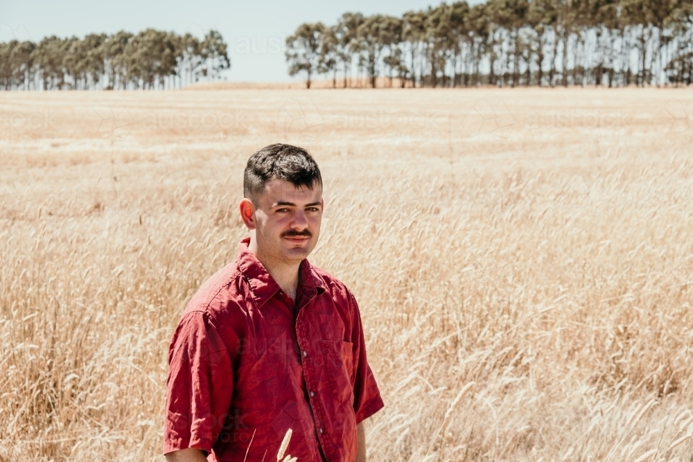 Image of Young man with a rural background. - Austockphoto