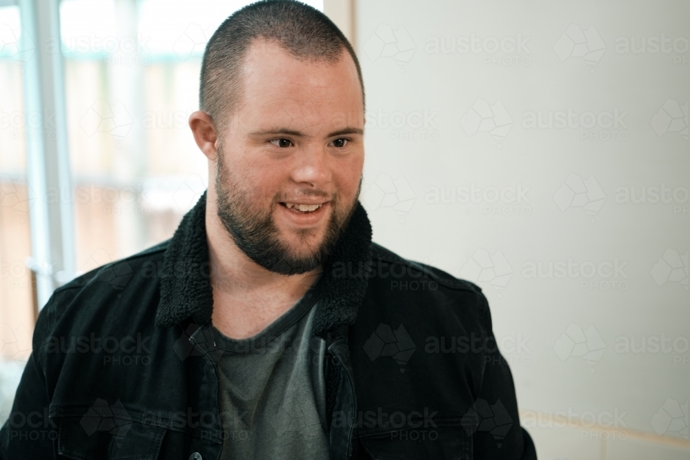 Young Man with Down syndrome and Black Jacket - Australian Stock Image