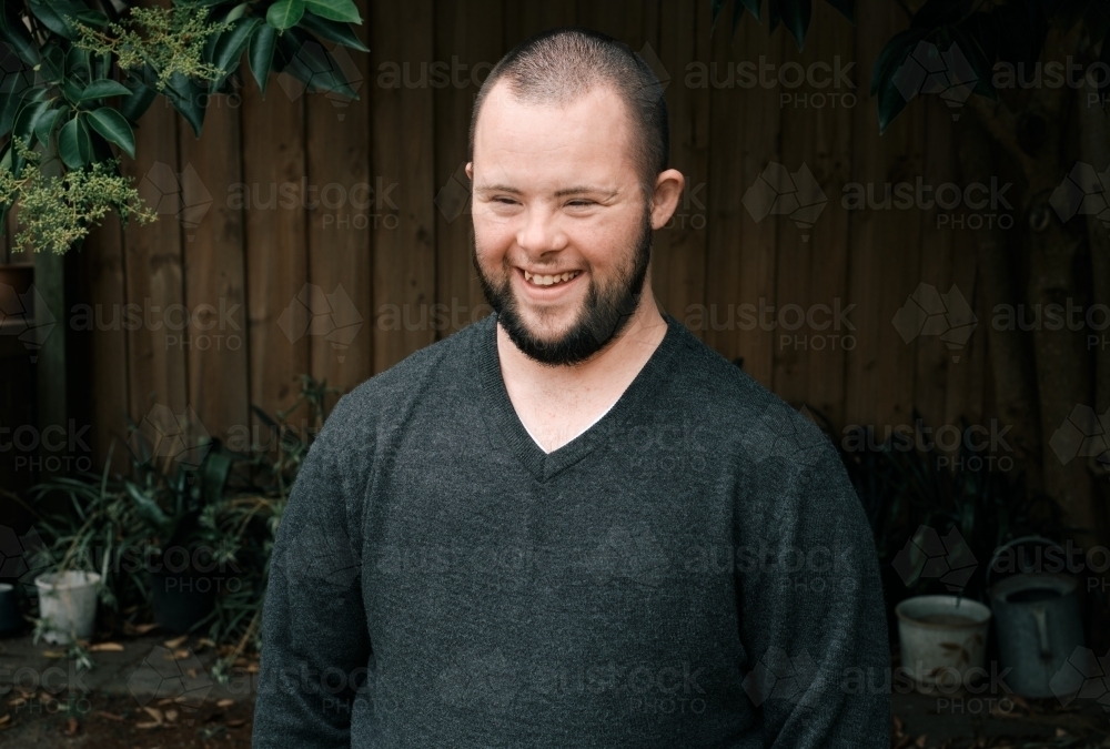 Young Man with Down Syndrome in Backyard - Australian Stock Image