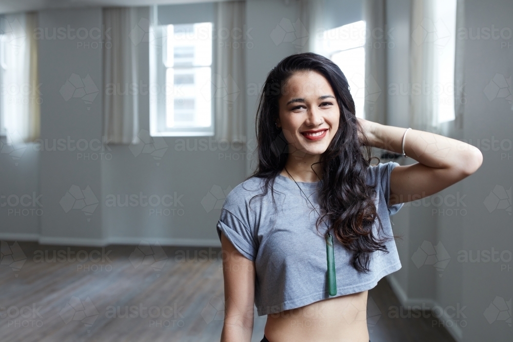 Young Maori dancer standing in studio - Australian Stock Image