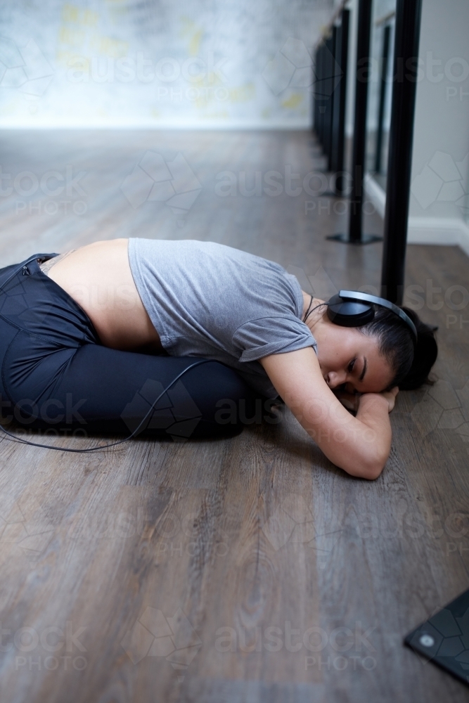 Young Maori dancer stretching at dance studio - Australian Stock Image