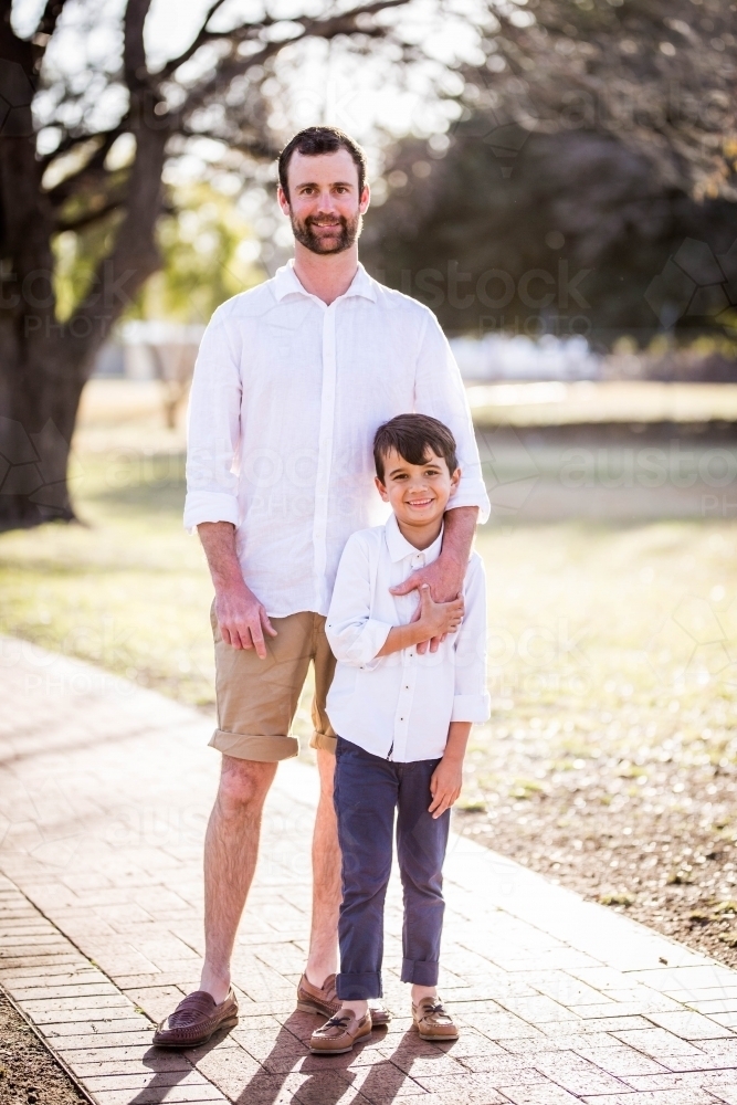 Image of Young mixed race aboriginal and caucasian boy holding father's hand Austockphoto