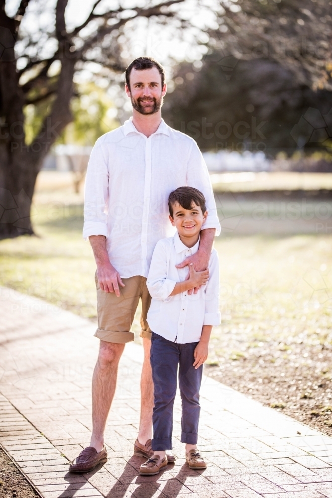 Young mixed race aboriginal and caucasian boy holding father's hand - Australian Stock Image