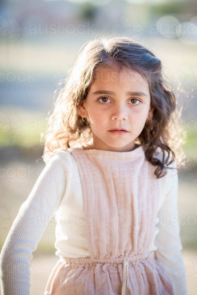 Young mixed race aboriginal and caucasian girl looking serious - Australian Stock Image