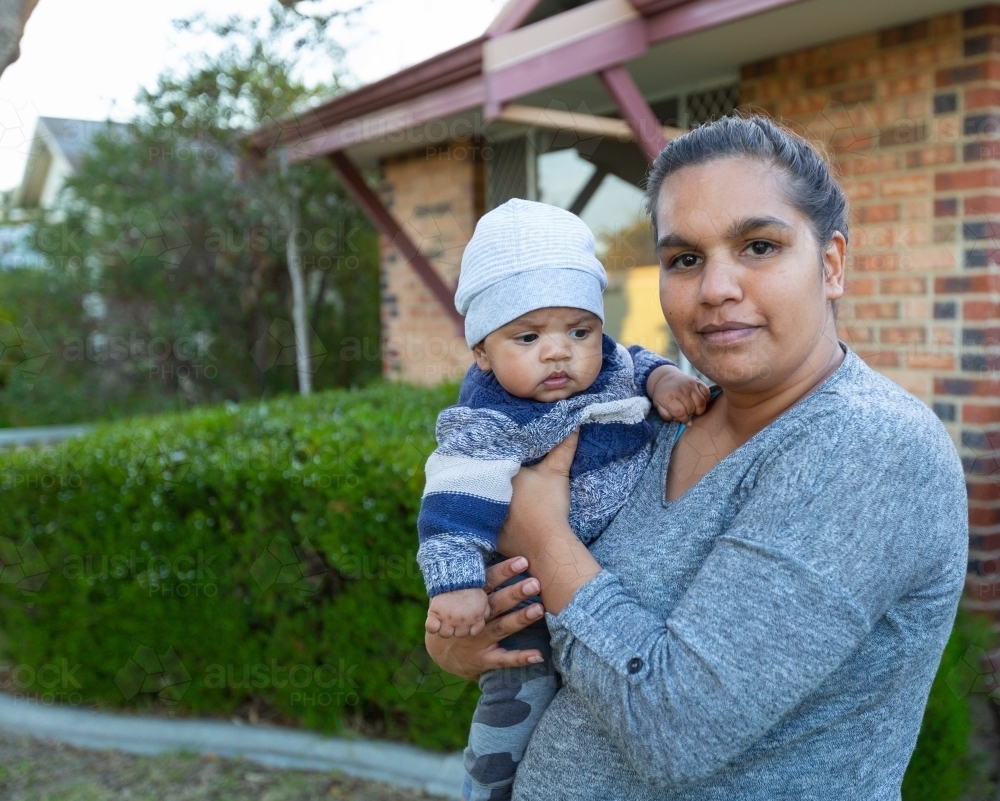Young mother holding her baby outside - Australian Stock Image